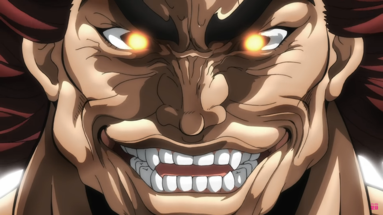 Yujiro sorrindo de forma maléfica enquanto um brilho vermelho sai de seus olhos, demonstrando animação